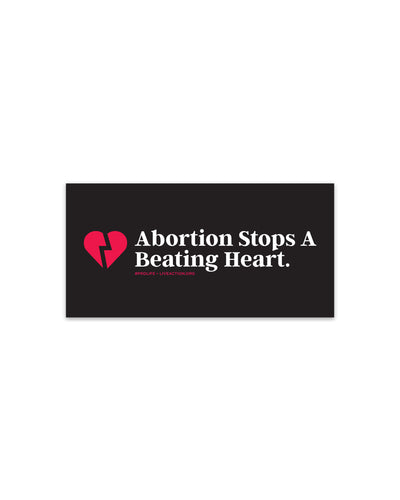 A black rectangle sticker with a red broken heart on the left and "Abortion Stops A Beating Heart." typed in white font. Underneath this text in small red text is the hashtag #ProLife and Live Action's website.