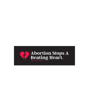 A black bumper sticker with a red broken heart on the left and "Abortion Stops A Beating Heart." typed in white font. Underneath this text in small red text is the hashtag #ProLife and Live Action's website.